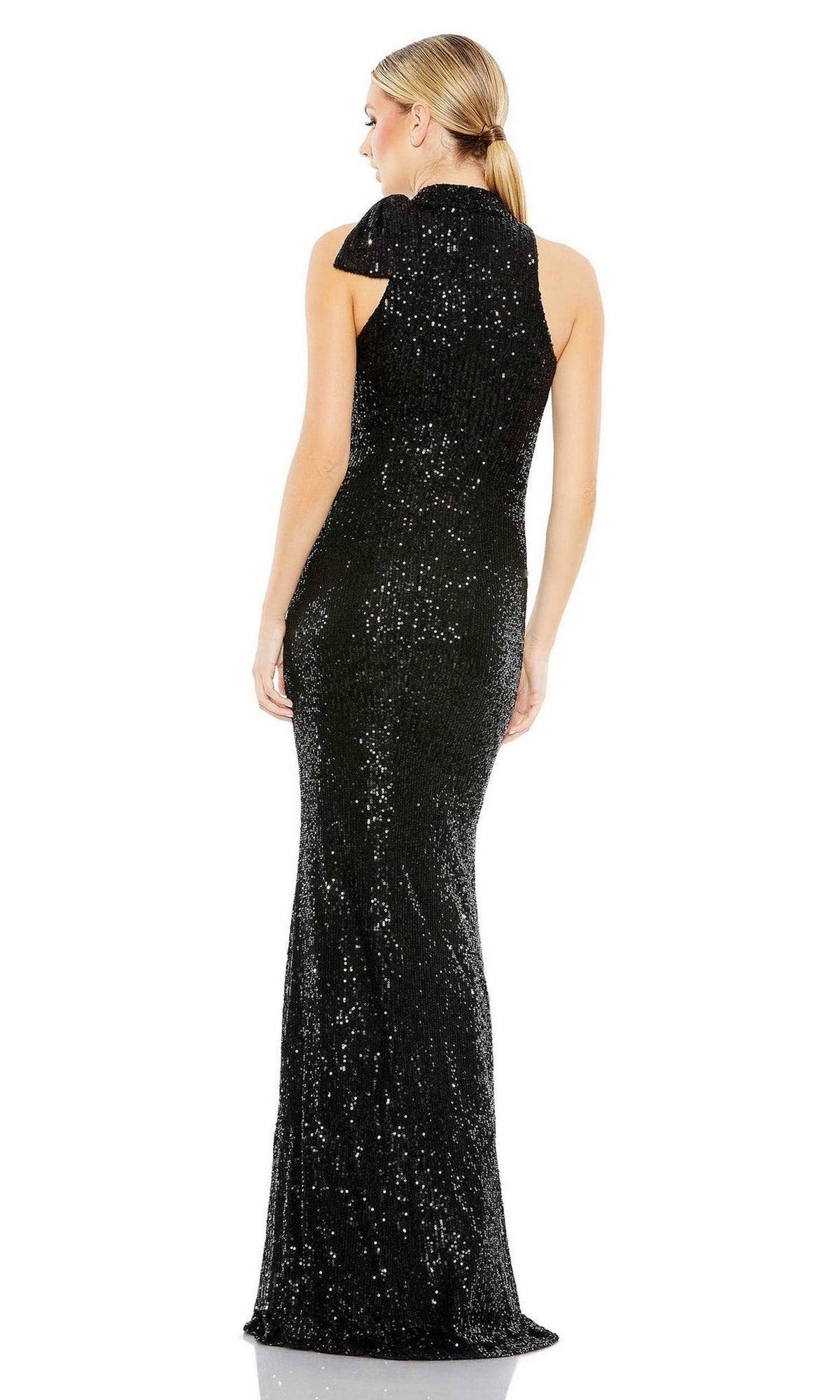 A woman with blonde hair in a low ponytail, facing away from the camera, wears the Mac Duggal 11280 Bow Long Sequin Formal Dress, sleeveless and floor-length, against a plain white background.